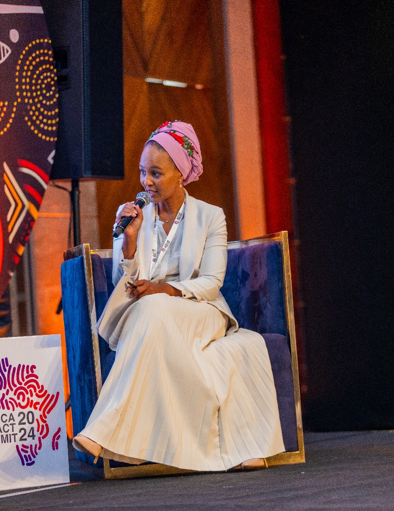 A speaker on stage at the Africa Impact Summit