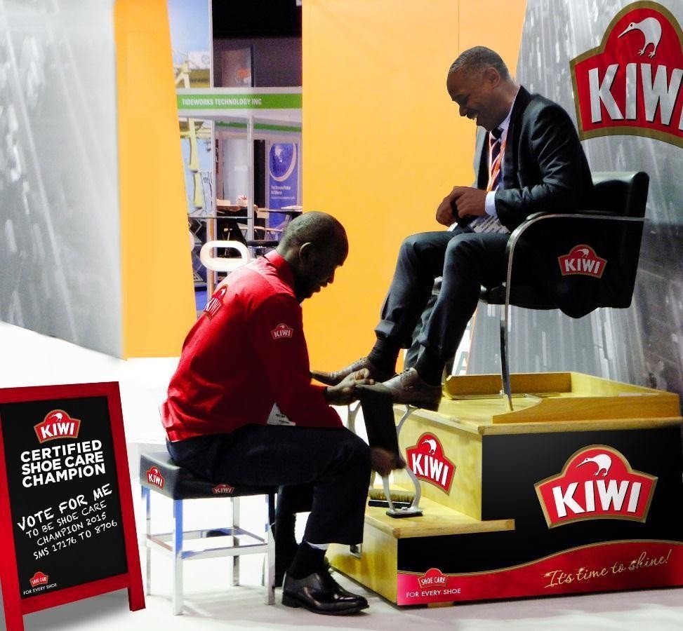 KIWI Shoe Care Champions booth with a shoe shine in progress